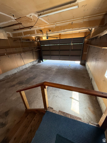 328 Heather Ridge Circle Sandy, UT 84070 - Photo 19 of 32 Spacious garage with an automatic overhead door, concrete flooring, and an exposed ceiling