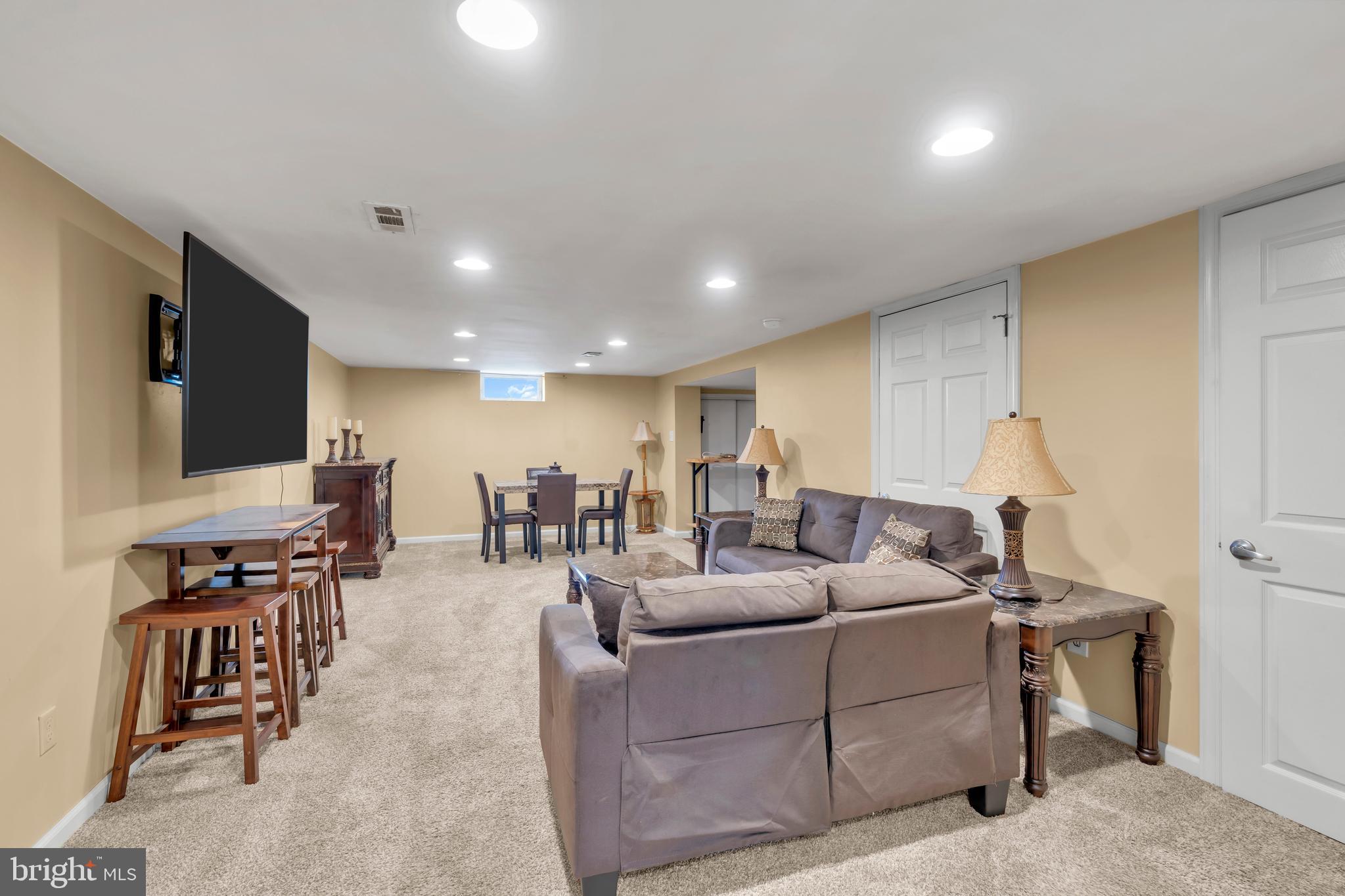 516 River Drive Riverside, NJ 08075 - Photo 28 of 82 a living room with couches and a flat screen tv with kitchen view