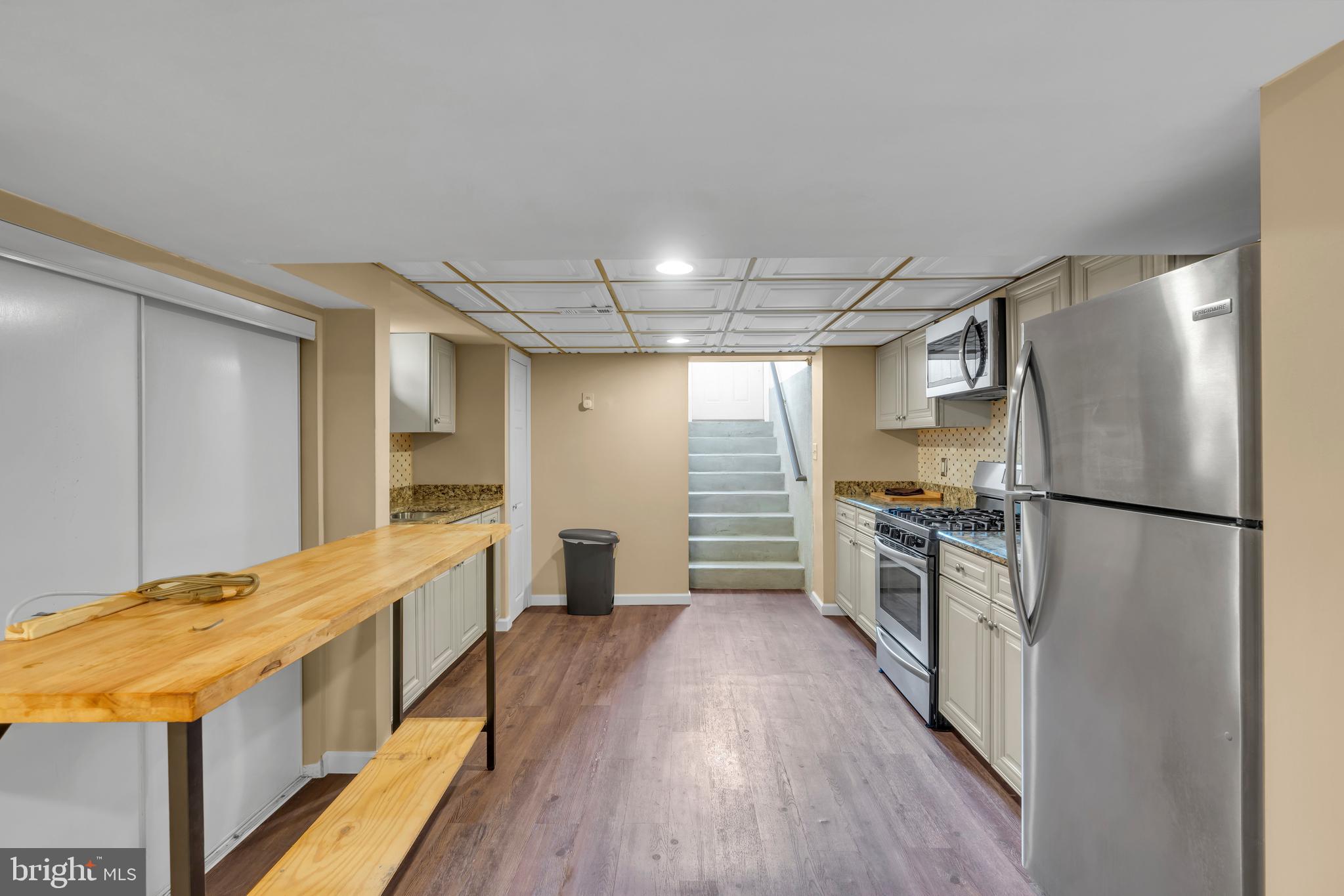 516 River Drive Riverside, NJ 08075 - Photo 34 of 82 a kitchen with stainless steel appliances a refrigerator and a wooden floor