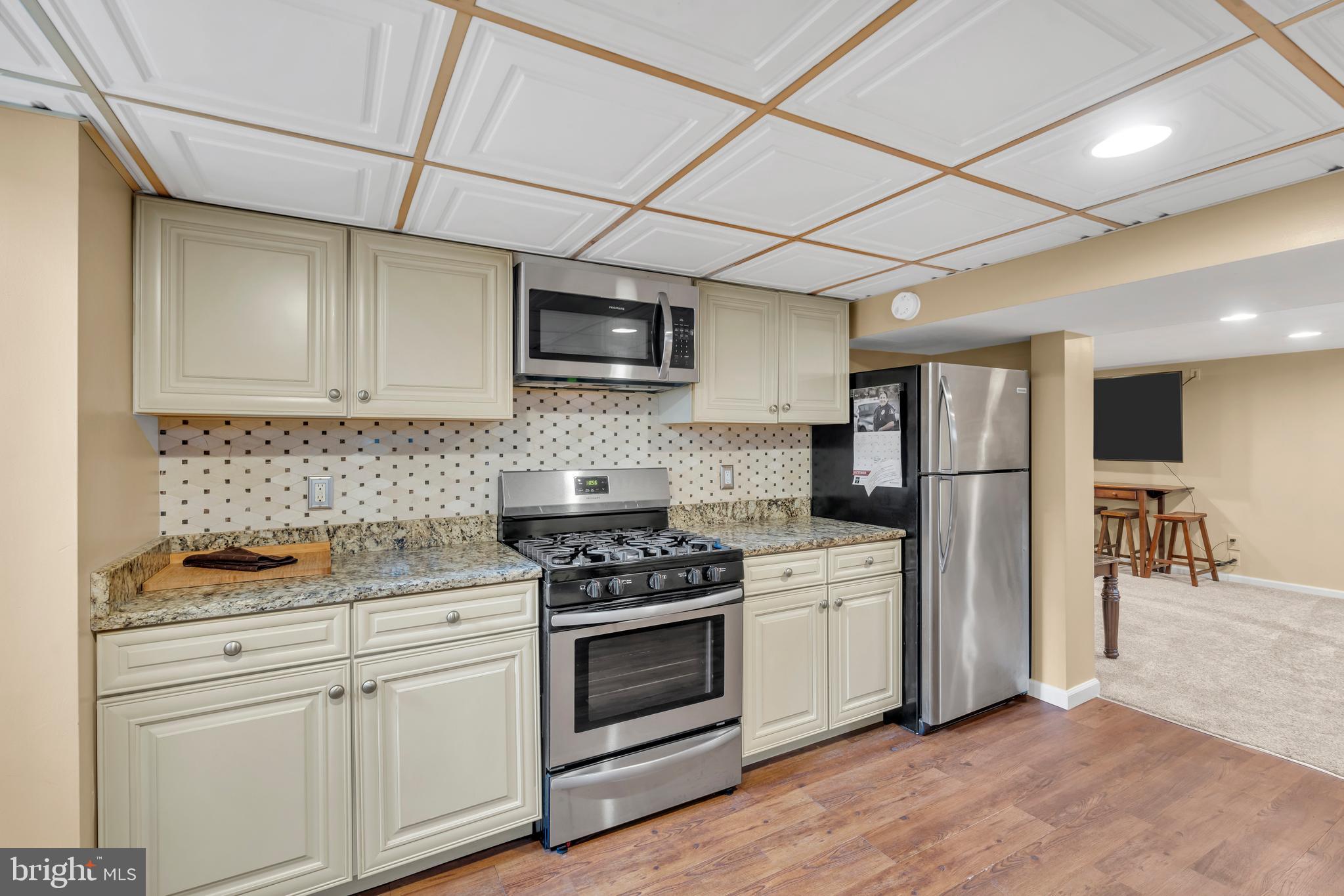 516 River Drive Riverside, NJ 08075 - Photo 38 of 82 a kitchen with stainless steel appliances white cabinets and a stove top oven