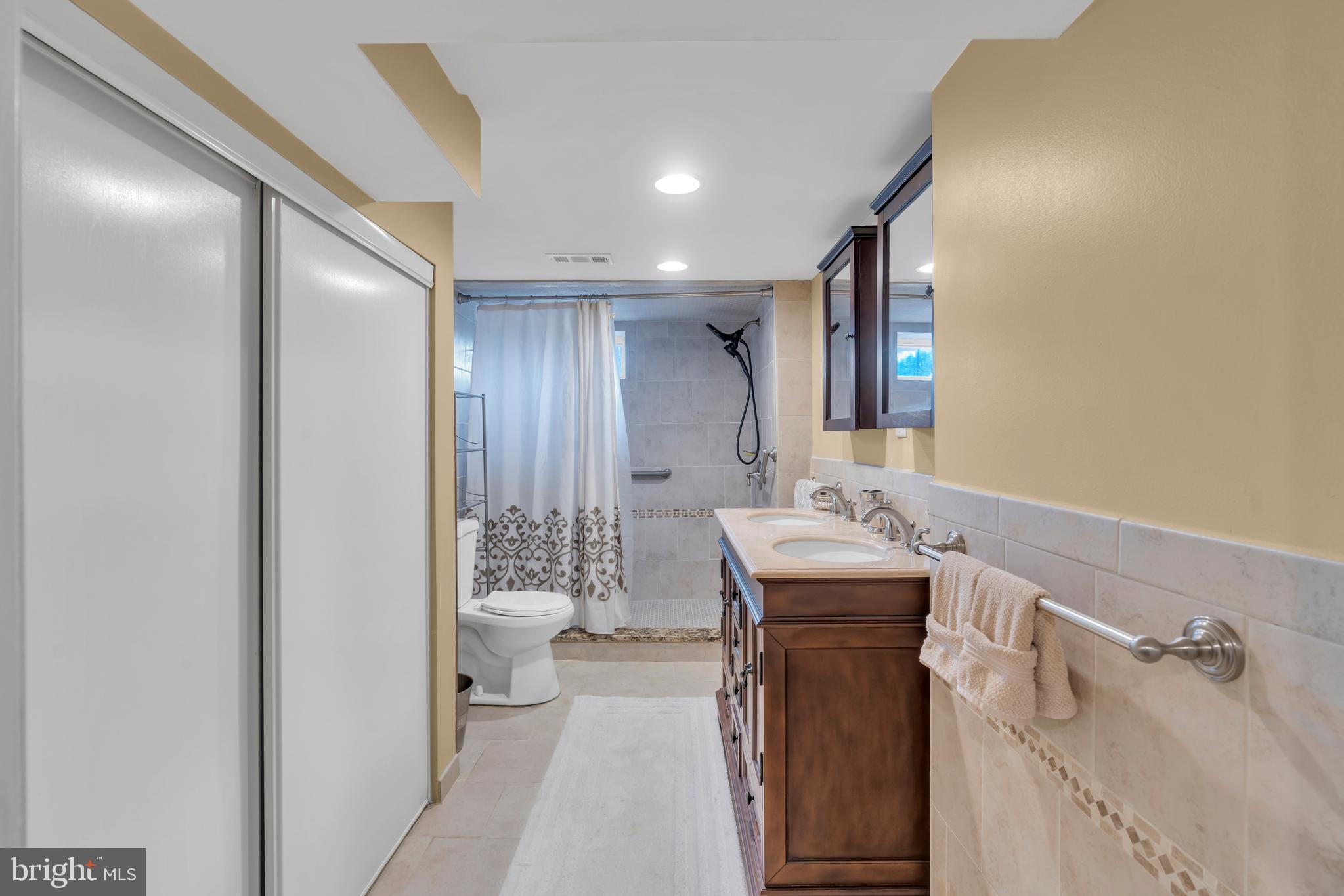 516 River Drive Riverside, NJ 08075 - Photo 40 of 82 a bathroom with a sink a toilet and mirror