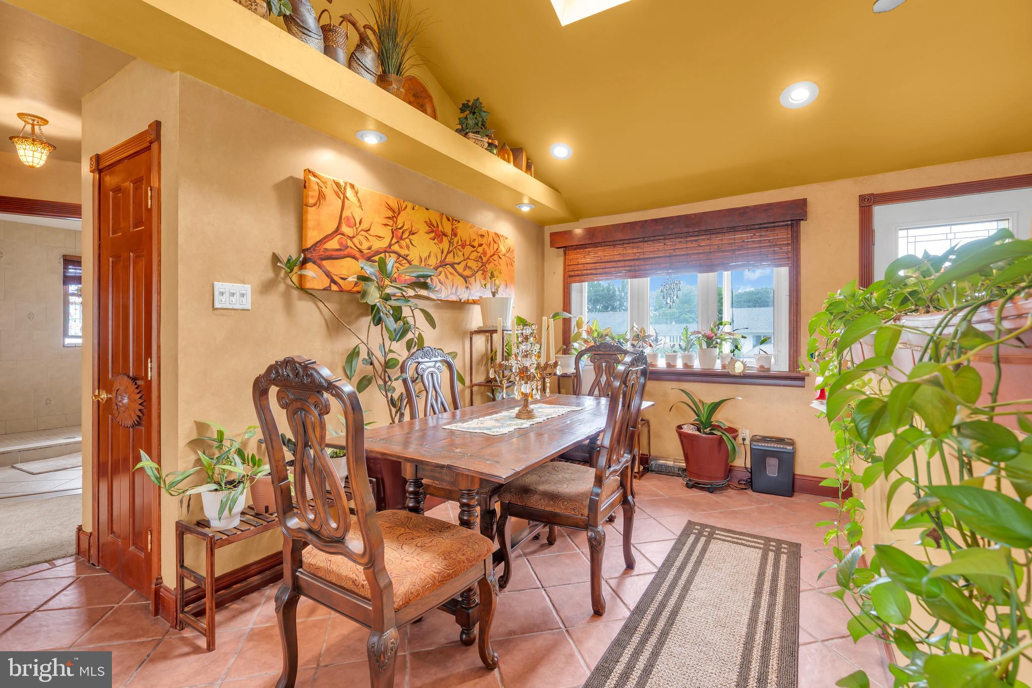 516 River Drive Riverside, NJ 08075 - Photo 5 of 82 a view of a patio with table and chairs potted plants with wooden floor