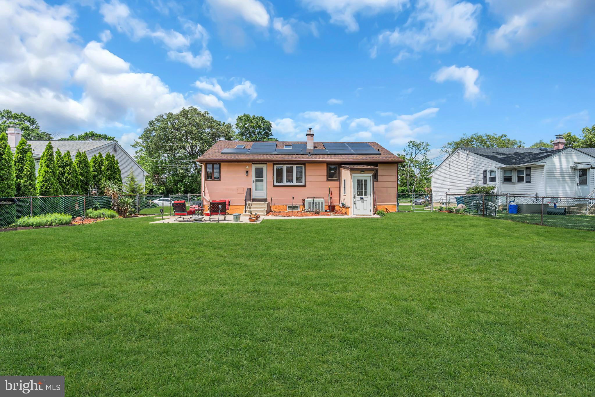 516 River Drive Riverside, NJ 08075 - Photo 60 of 82 a front view of a house with a garden and trees