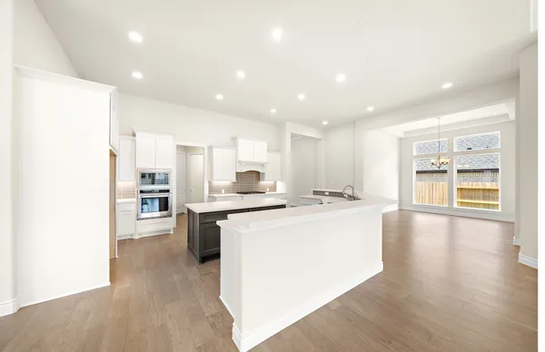 a kitchen with stainless steel appliances kitchen island granite countertop a sink and cabinets
