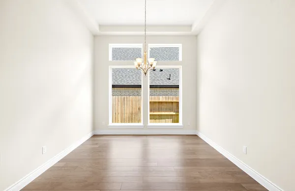 a view of a kitchen with kitchen island a chandelier wooden floor and a living room
