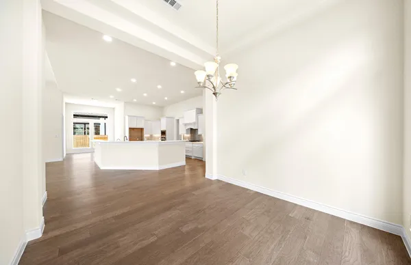a kitchen with stainless steel appliances granite countertop a stove top oven a sink and a refrigerator