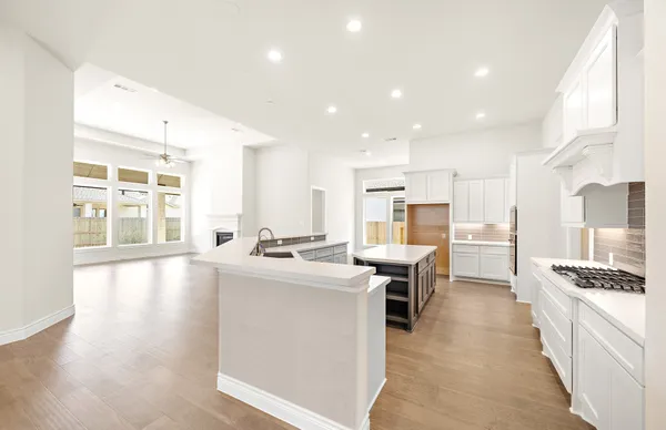 a large kitchen with a stove top oven