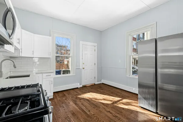 a kitchen with a stove and a refrigerator
