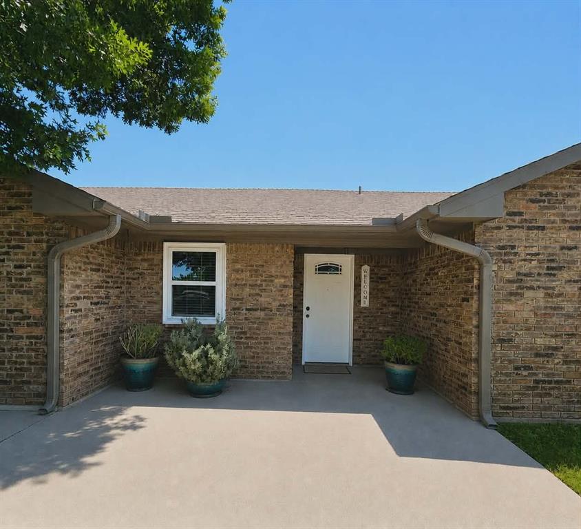 14752 Ranch Road Forney, TX 75126 - Photo 2 of 40 Brick exterior with a Front porch with overed entry, white front door, and a single window with white trim