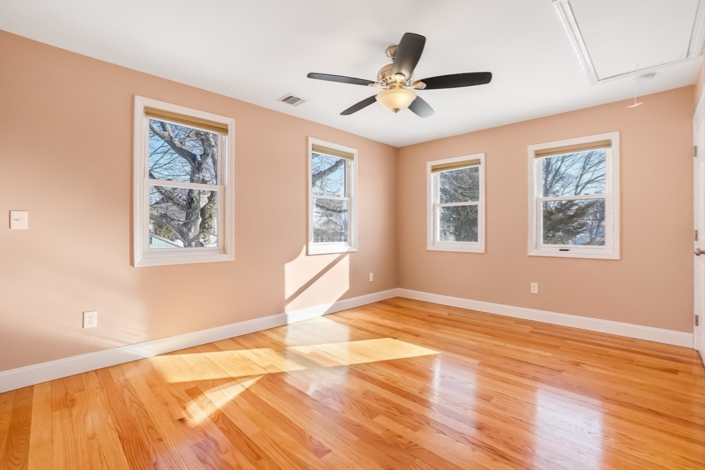 52 Savory Street, Unit 52 Lynn, MA 01904 - Photo 12 of 29 a view of an empty room with wooden floor and a window