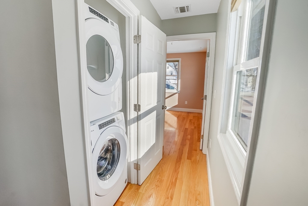52 Savory Street, Unit 52 Lynn, MA 01904 - Photo 15 of 29 a view of a hallway with washer and dryer