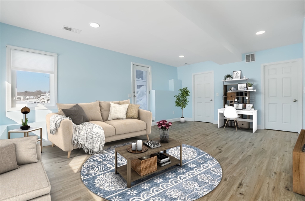 52 Savory Street, Unit 52 Lynn, MA 01904 - Photo 18 of 29 a living room with furniture and white table with wooden floor