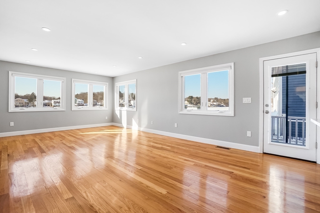 52 Savory Street, Unit 52 Lynn, MA 01904 - Photo 5 of 29 a view of empty room with wooden floor and fan