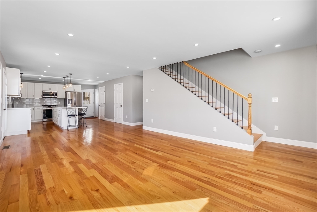 52 Savory Street, Unit 52 Lynn, MA 01904 - Photo 6 of 29 a view of kitchen and hall with wooden floor