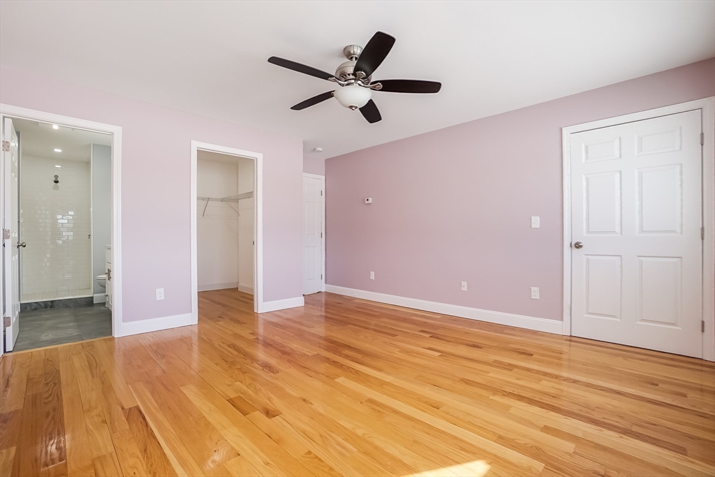 52 Savory Street, Unit 52 Lynn, MA 01904 - Photo 9 of 29 an empty room with wooden floor and ceiling fan