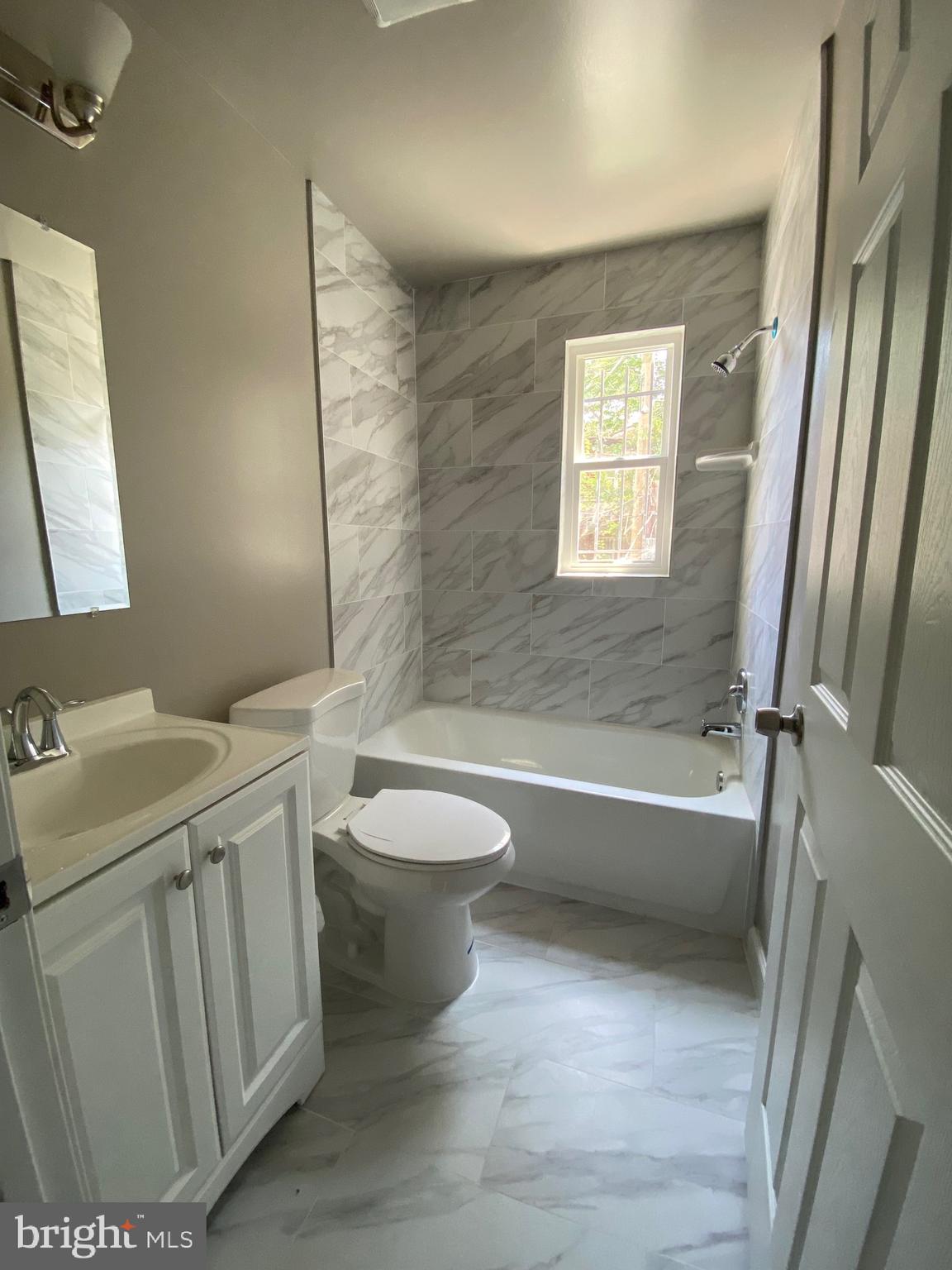 52 Forrester Street Southwest Washington, DC 20032 - Photo 13 of 18 a bathroom with a toilet a sink and bathtub
