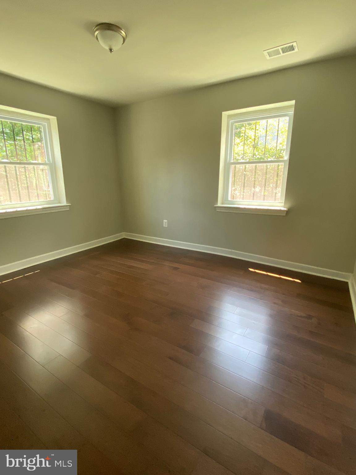 52 Forrester Street Southwest Washington, DC 20032 - Photo 17 of 18 an empty room with wooden floor and windows