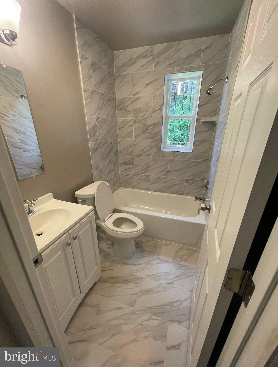 52 Forrester Street Southwest Washington, DC 20032 - Photo 2 of 18 a bathroom with a toilet a sink and a bathtub