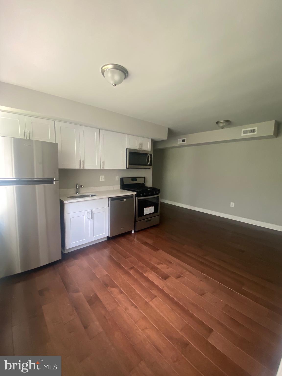 52 Forrester Street Southwest Washington, DC 20032 - Photo 9 of 18 a kitchen with stainless steel appliances a refrigerator and a stove top oven