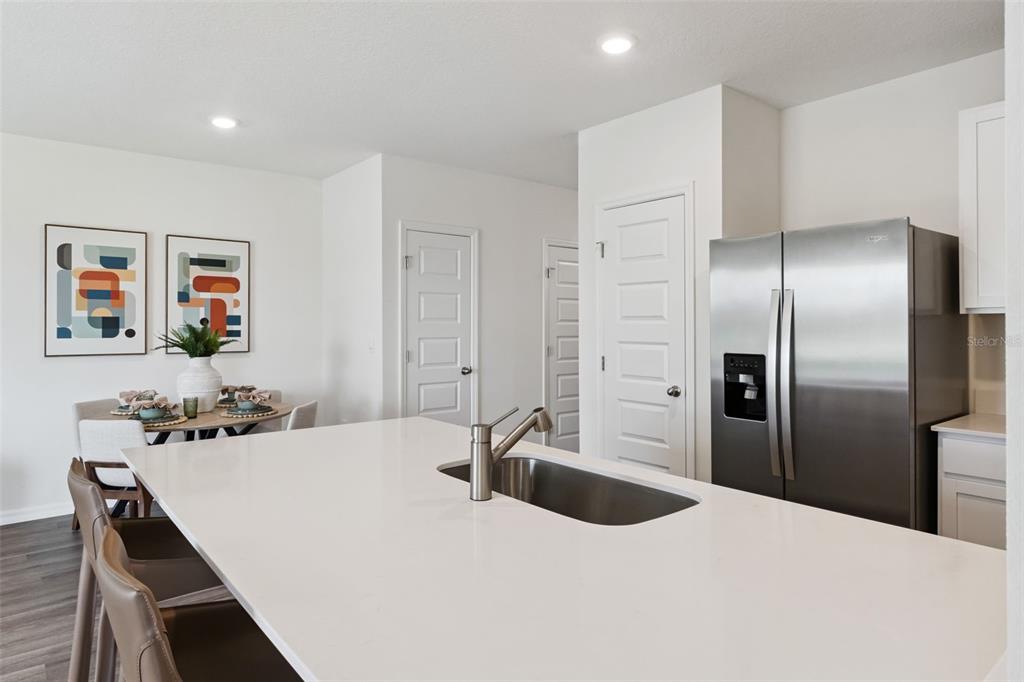 4356 Butterscotch Circle Lakeland, FL 33811 - Photo 11 of 30 a kitchen with stainless steel appliances kitchen island a refrigerator sink and stove