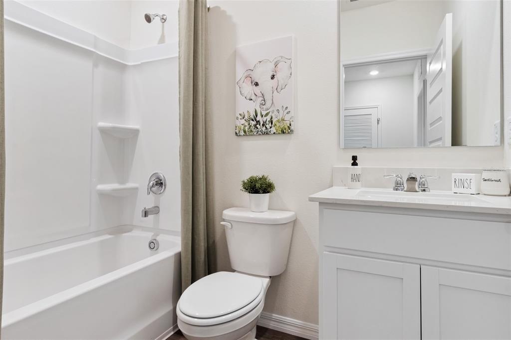 4356 Butterscotch Circle Lakeland, FL 33811 - Photo 24 of 30 a bathroom with a sink a toilet and shower