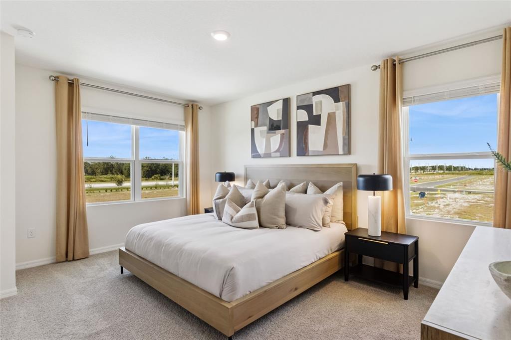 4356 Butterscotch Circle Lakeland, FL 33811 - Photo 26 of 30 a bedroom with a bed and a large window