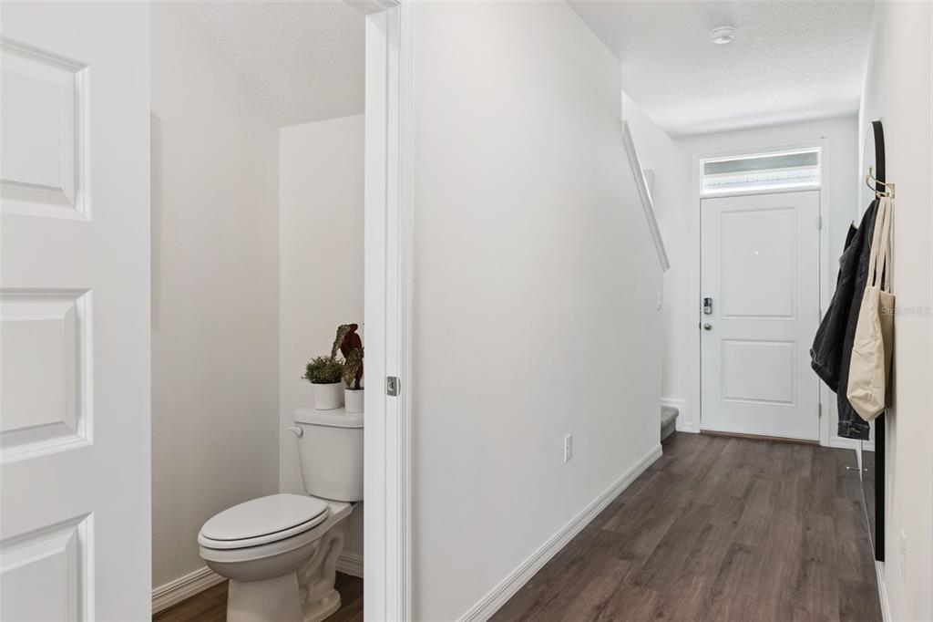 4356 Butterscotch Circle Lakeland, FL 33811 - Photo 3 of 30 a bathroom with a granite countertop toilet and a wooden floor
