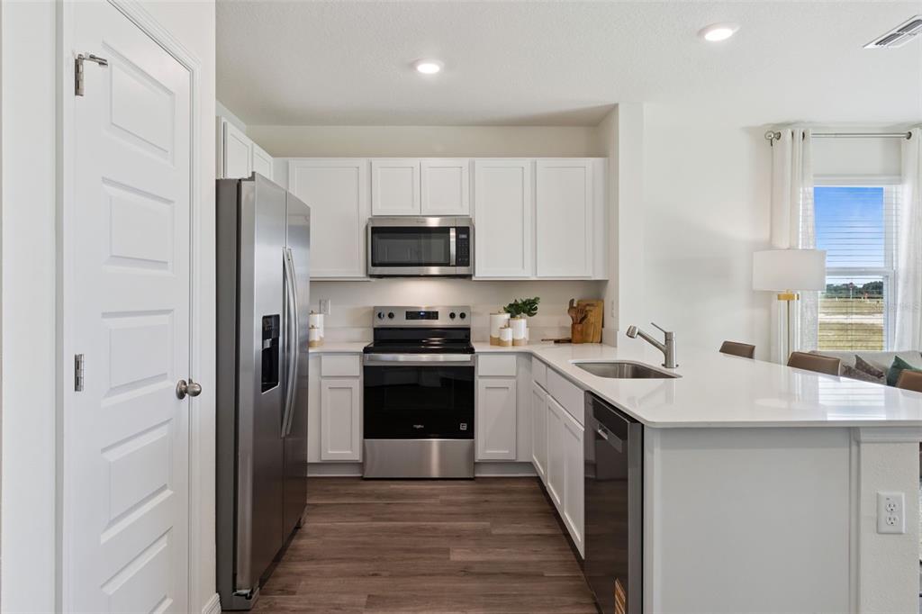 4356 Butterscotch Circle Lakeland, FL 33811 - Photo 7 of 30 a kitchen with a sink appliances and cabinets