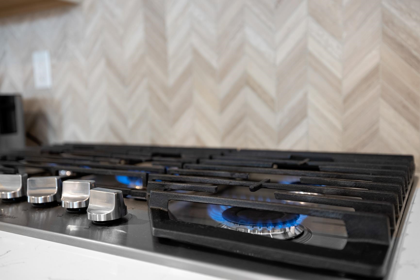 5628 Gerber Road Arlington, TN 38002 - Photo 20 of 40 Kitchen view of stainless steel gas stovetop, backsplash, and dark stone counters