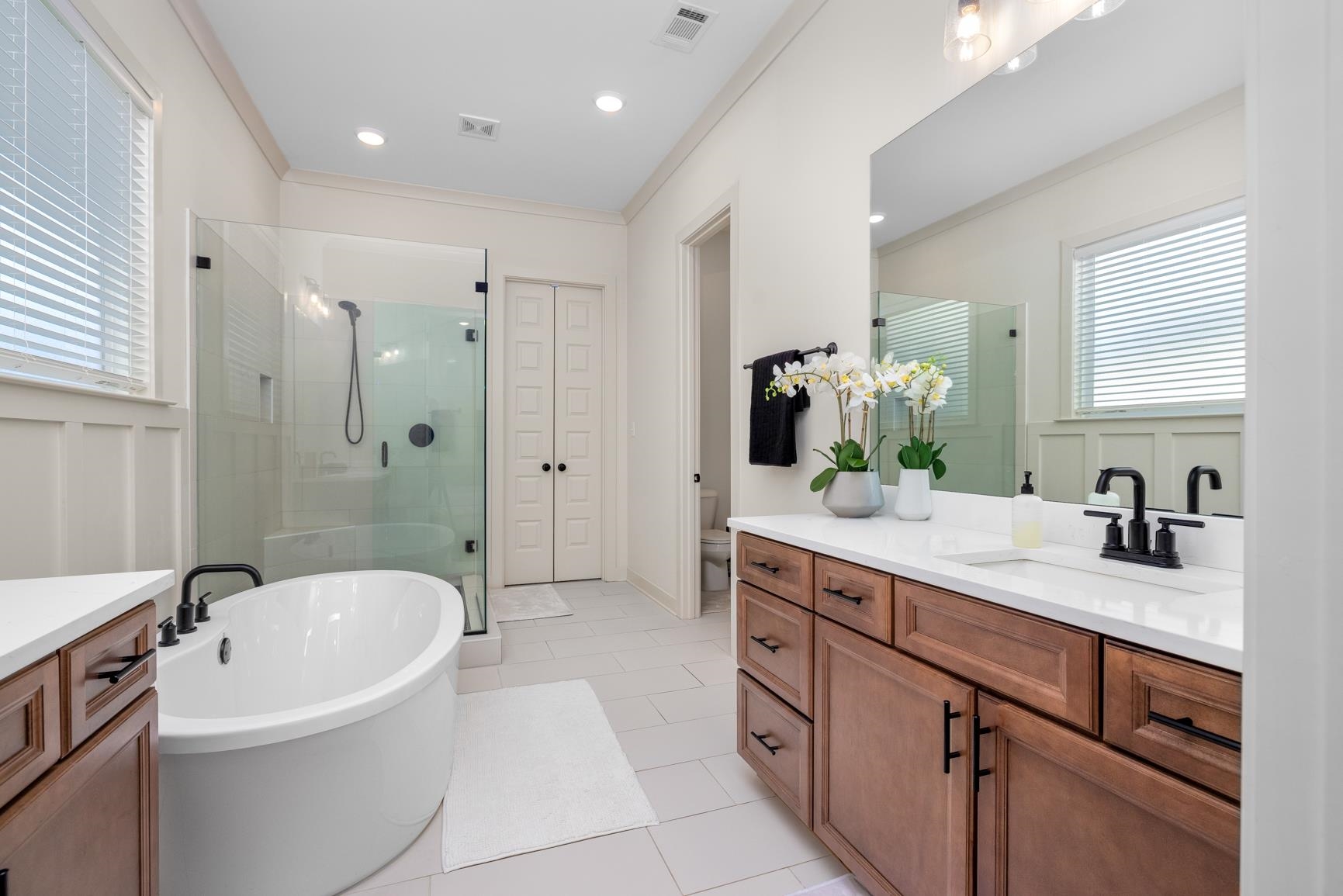 5628 Gerber Road Arlington, TN 38002 - Photo 23 of 40 Bathroom with vanity, a stall shower, a freestanding bath, crown molding, and light tile patterned floors