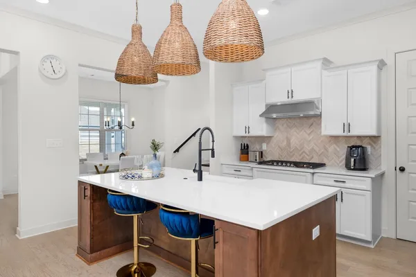 a kitchen with stainless steel appliances a stove a sink and a refrigerator
