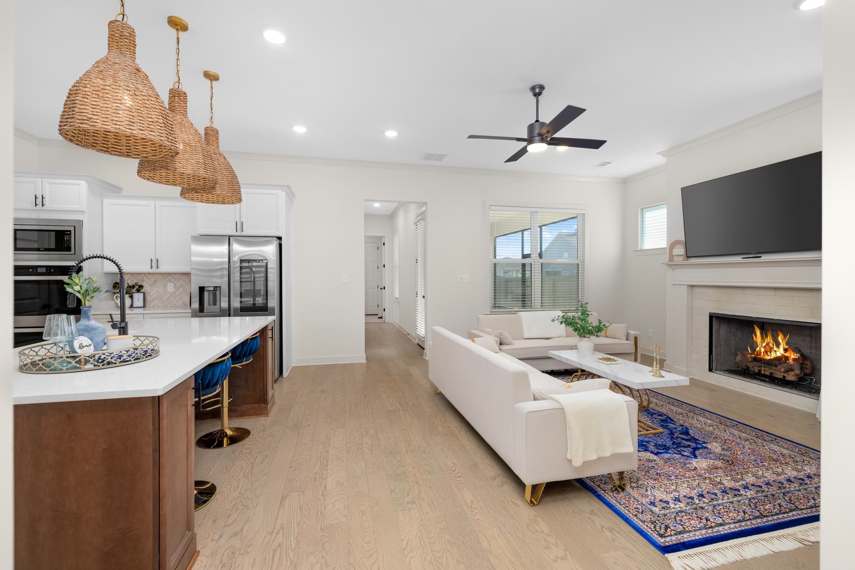 5628 Gerber Road Arlington, TN 38002 - Photo 34 of 40 Living area with crown molding, a warm lit fireplace, light wood-style flooring, recessed lighting, and ceiling fan