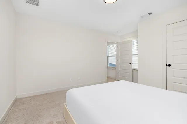 a bedroom with a bed and a cabinets