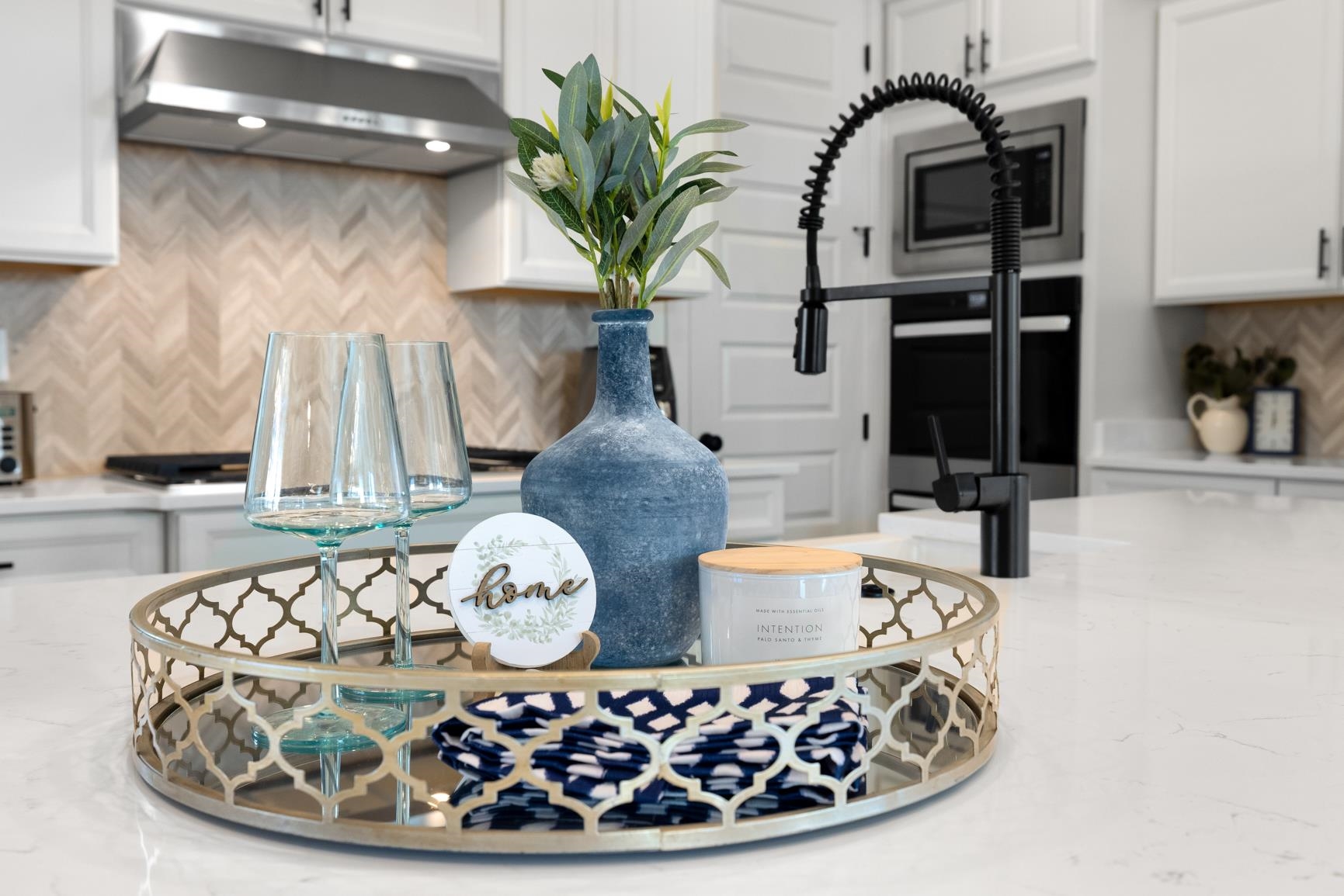 5628 Gerber Road Arlington, TN 38002 - Photo 7 of 40 Kitchen view of backsplash, white cabinets, and light stone counters