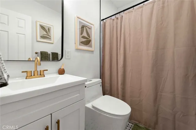 a bedroom with a bed and painting on the wall