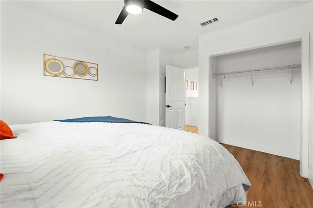 a bedroom with bed and painting on the wall