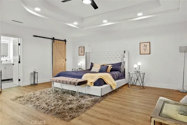 a spacious bedroom with a balcony a bed and a walk in closet