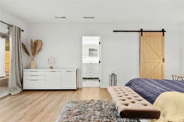 a dining room with furniture and a floor to ceiling window