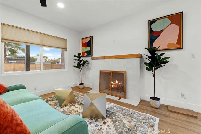 a living room with furniture a potted plant and a fireplace