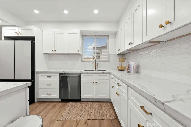 a kitchen with cabinets appliances and a window
