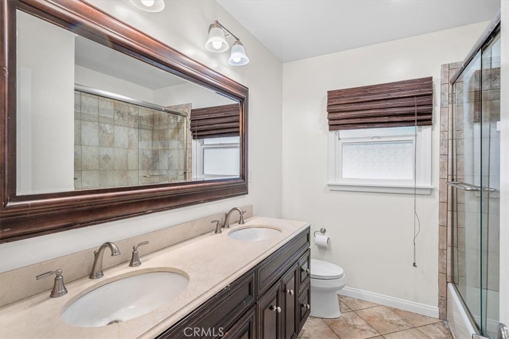 54 Ranchview Road Rolling Hills Estates, CA 90274 - Photo 27 of 60 a bathroom with a sink a toilet a mirror and shower