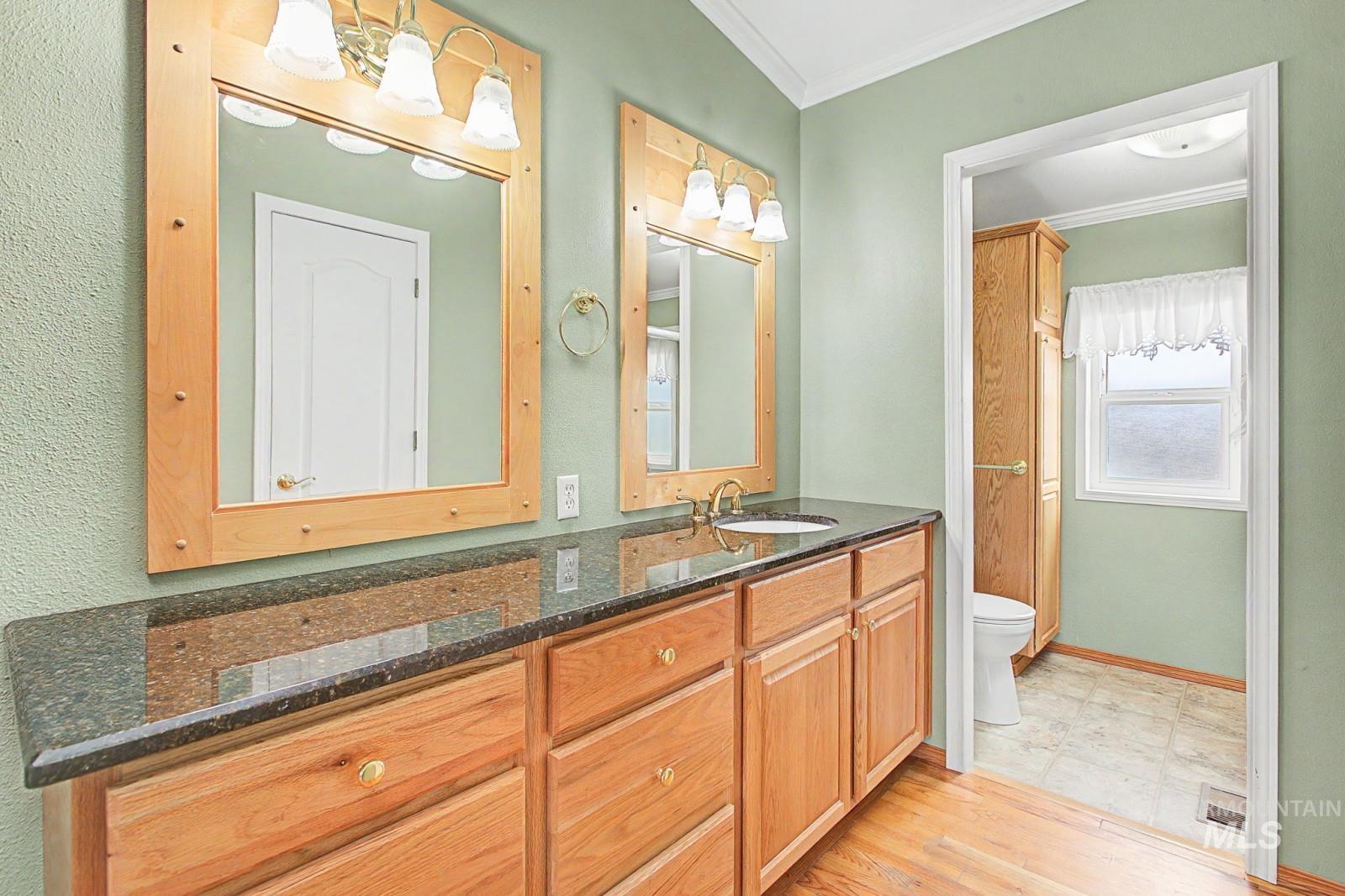 1480 Birch Street Clarkston, WA 99403 - Photo 18 of 30 Full bathroom featuring vanity, crown molding, and light wood-type flooring