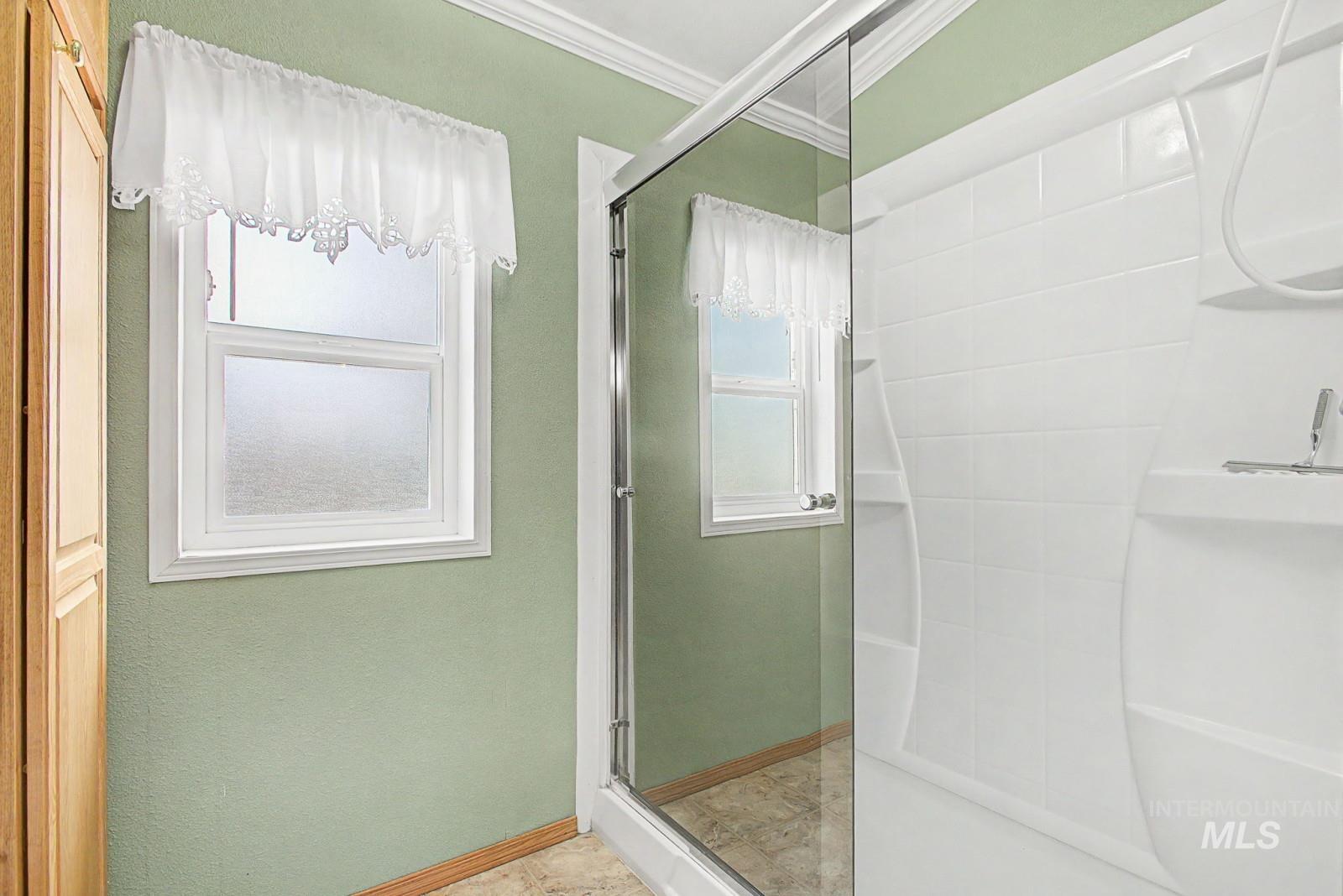1480 Birch Street Clarkston, WA 99403 - Photo 19 of 30 Full bathroom with a shower stall and ornamental molding