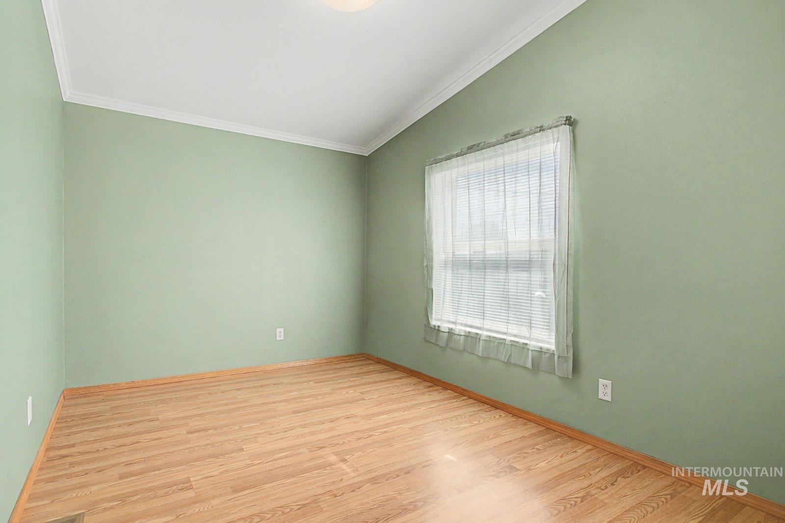 1480 Birch Street Clarkston, WA 99403 - Photo 24 of 30 Empty room with vaulted ceiling, light wood-type flooring, and ornamental molding