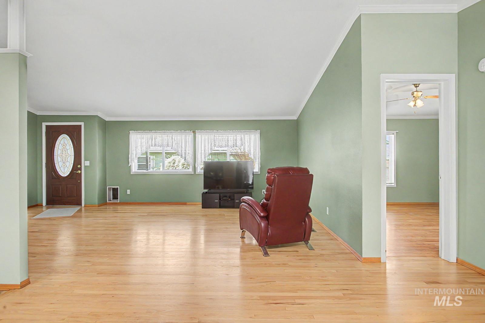 1480 Birch Street Clarkston, WA 99403 - Photo 5 of 30 Living area with ornamental molding, light wood-type flooring, and a ceiling fan