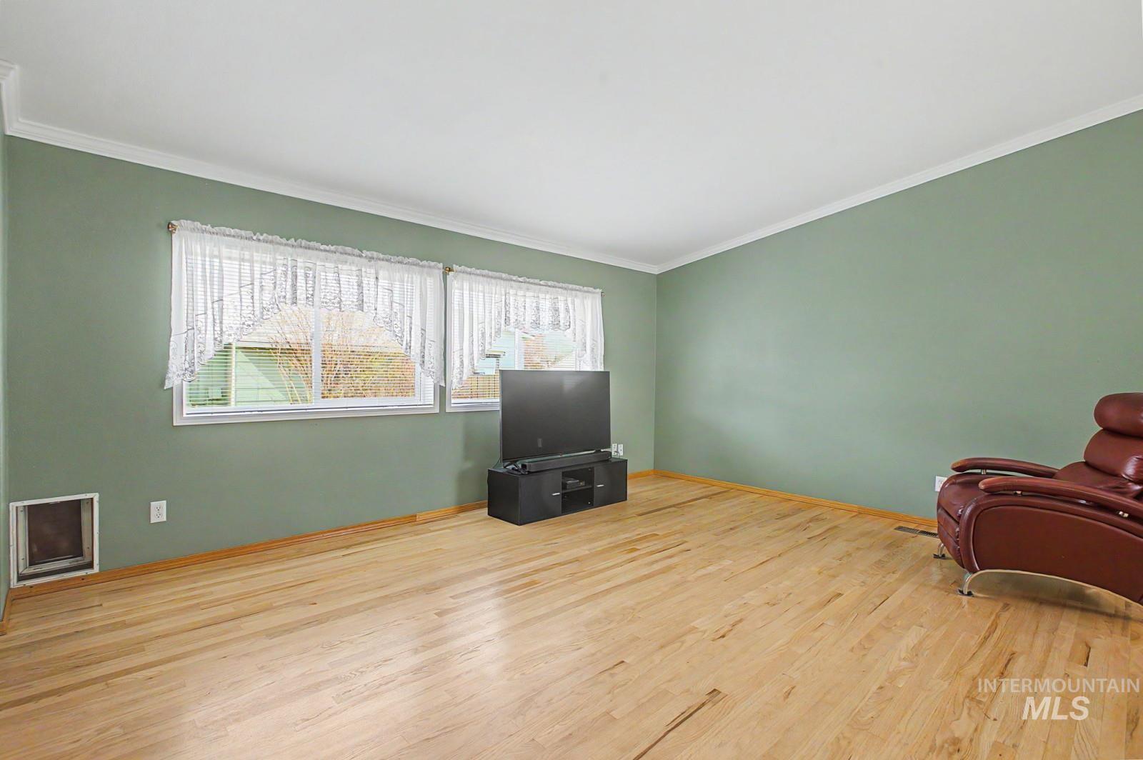 1480 Birch Street Clarkston, WA 99403 - Photo 8 of 30 Sitting room featuring light wood-style floors, healthy amount of natural light, and crown molding