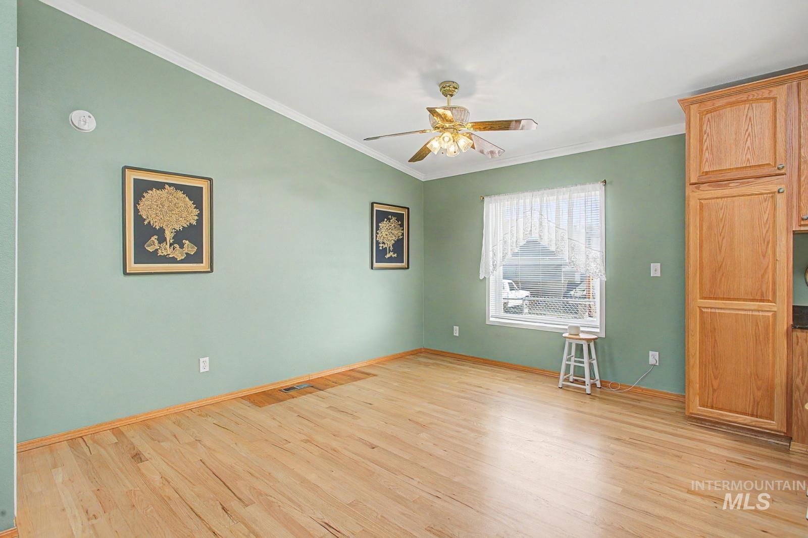 1480 Birch Street Clarkston, WA 99403 - Photo 9 of 30 Unfurnished room featuring ceiling fan, crown molding, and light wood-style floors