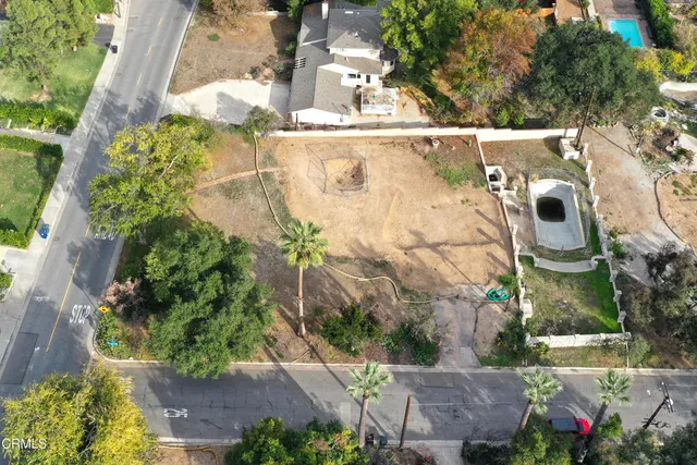 an aerial view of residential houses with outdoor space