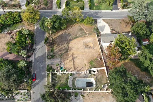 an aerial view of a residential building with an outdoor space