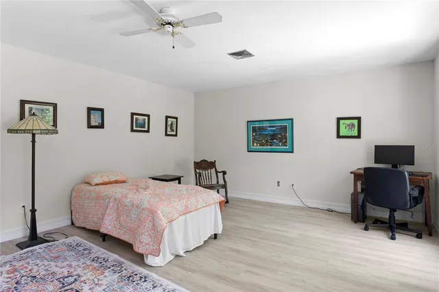 a bed room with a bed and a chandelier